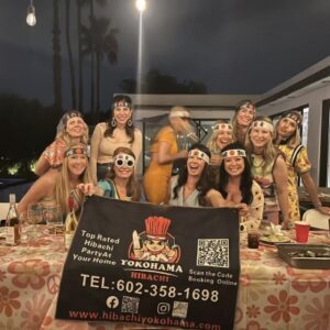 Wedding celebration hibachi catering with guests holding a Yokohama Hibachi banner